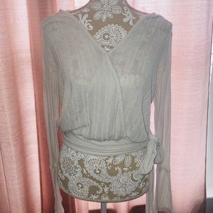 Cropped white top with tie on the side.